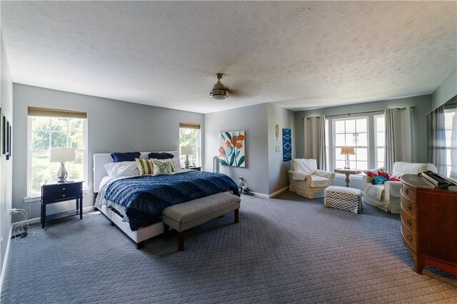 bedroom with baseboards, multiple windows, and carpet