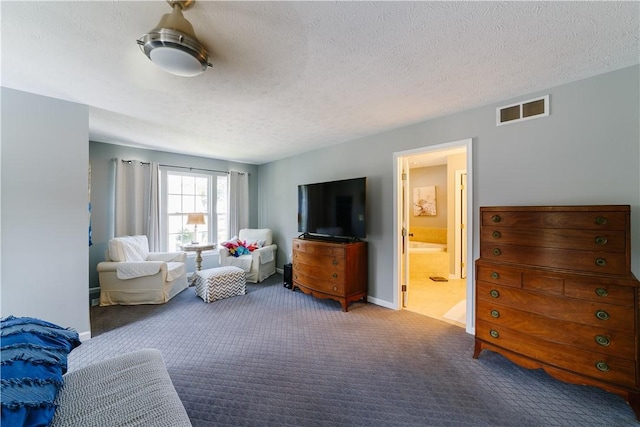 carpeted living room featuring baseboards, a textured ceiling, and visible vents