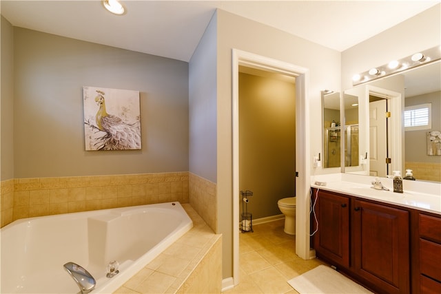 bathroom with vanity, toilet, tile patterned floors, a shower stall, and a garden tub