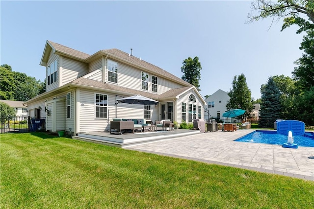back of property with fence, a deck, an outdoor pool, an outdoor living space, and a lawn