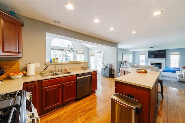 kitchen featuring a sink, dishwasher, dark brown cabinets, and open floor plan