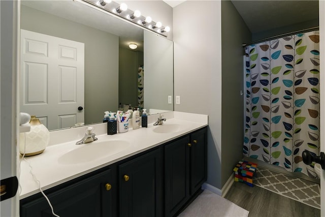 full bathroom with a sink, double vanity, wood finished floors, and a shower with shower curtain