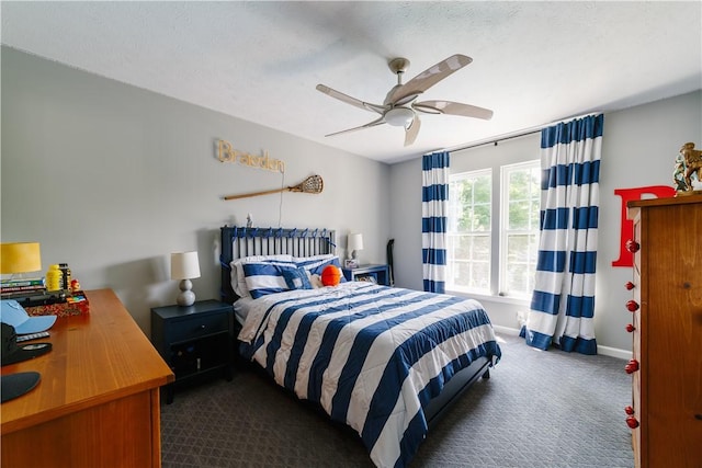 bedroom featuring baseboards, ceiling fan, and dark colored carpet