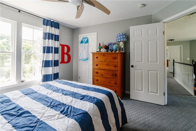 bedroom featuring dark carpet and ceiling fan