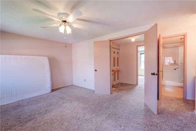 unfurnished bedroom featuring carpet floors and ceiling fan