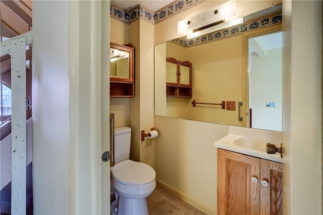 bathroom featuring tile patterned flooring, toilet, and vanity