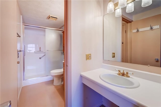 full bathroom featuring vanity, toilet, visible vents, and a stall shower