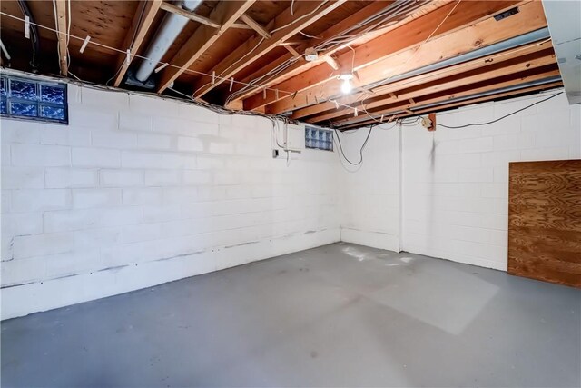 unfinished below grade area featuring concrete block wall