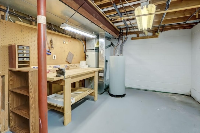 unfinished basement with water heater and a workshop area