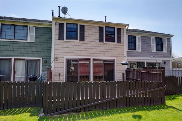rear view of property with fence