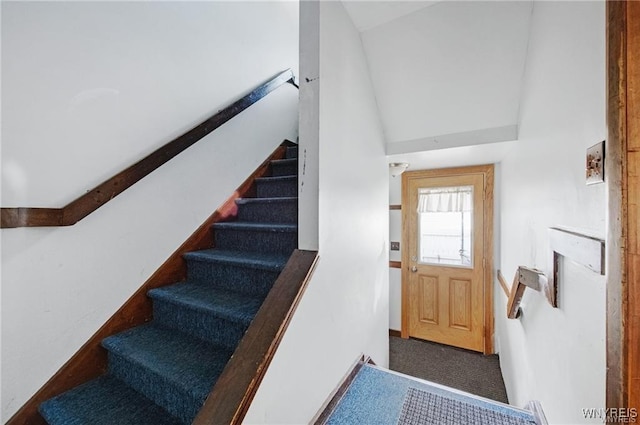stairway with high vaulted ceiling