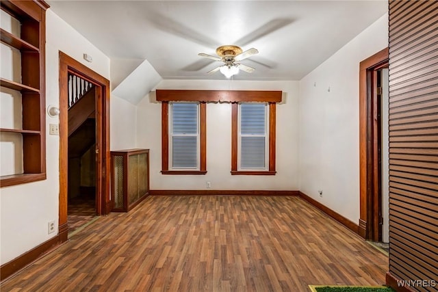 bonus room with baseboards, ceiling fan, and wood finished floors