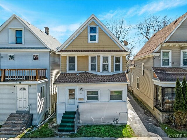 view of front of property with entry steps and a balcony