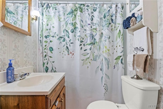 full bathroom with vanity, curtained shower, toilet, and wallpapered walls