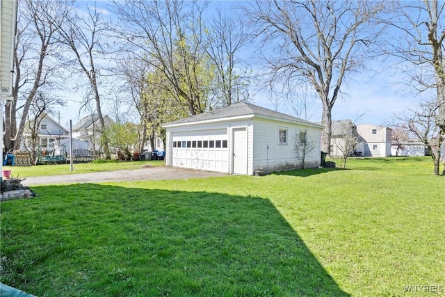 view of yard featuring an outbuilding and a detached garage