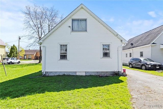 view of home's exterior with a lawn