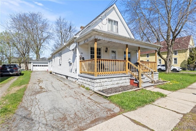 view of front of home featuring a porch, an outdoor structure, and a detached garage