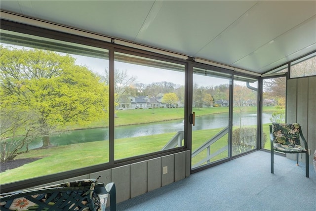 sunroom / solarium with a water view