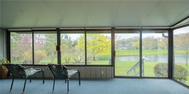sunroom / solarium with a water view and a healthy amount of sunlight