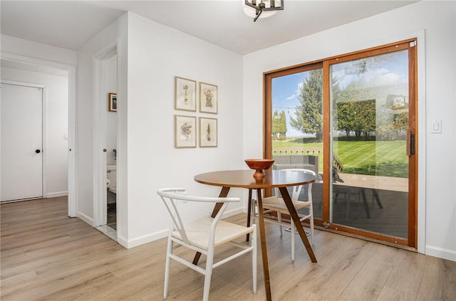 dining room featuring baseboards and light wood-style floors