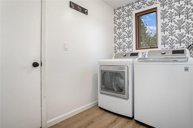 washroom with independent washer and dryer, laundry area, light wood-style flooring, baseboards, and wallpapered walls