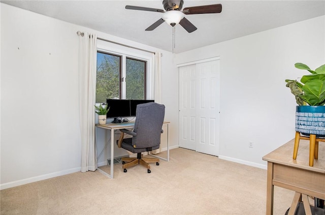 home office featuring carpet flooring, a ceiling fan, and baseboards