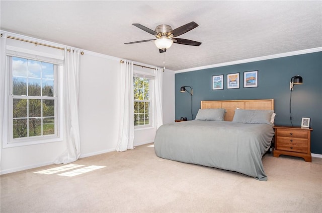 bedroom with crown molding, baseboards, and carpet flooring