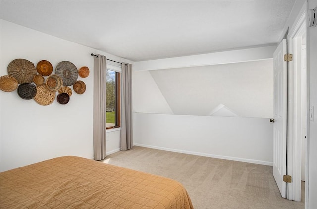 bedroom with baseboards, light colored carpet, and lofted ceiling