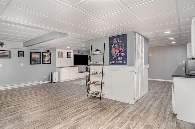 bar with recessed lighting, baseboards, a baseboard heating unit, and light wood-style floors