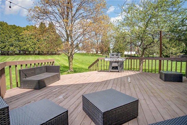 deck featuring a lawn and a grill