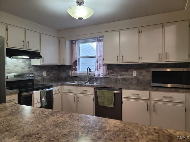 kitchen with decorative backsplash, appliances with stainless steel finishes, a sink, white cabinets, and under cabinet range hood