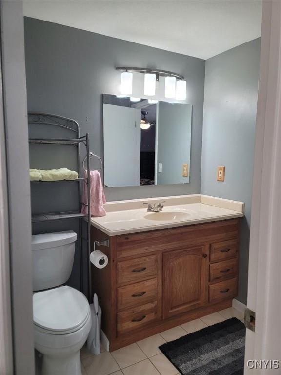 bathroom with vanity, tile patterned floors, and toilet