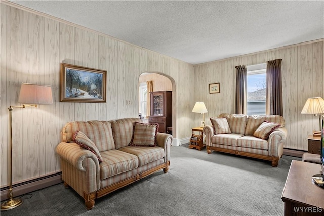 living room featuring arched walkways, a textured ceiling, a baseboard radiator, and carpet flooring