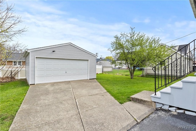 detached garage featuring fence