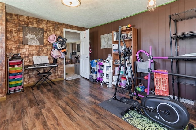 interior space with a textured ceiling and wood finished floors