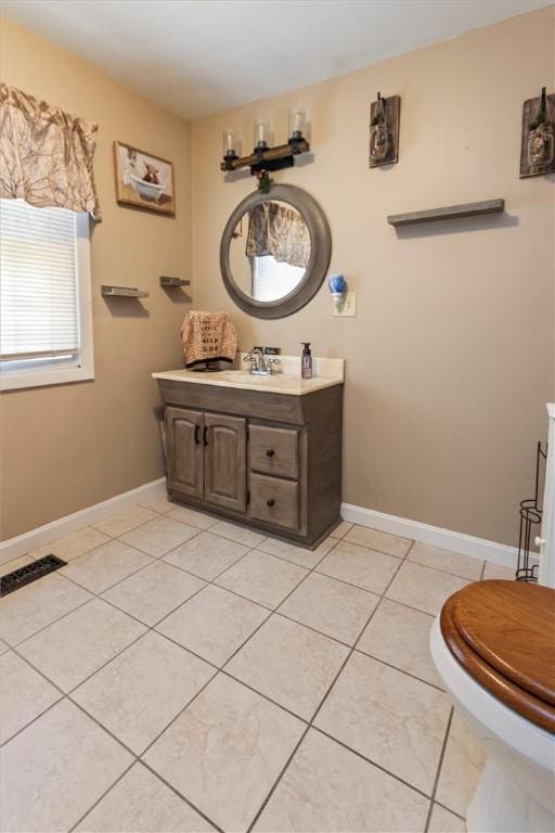 bathroom featuring vanity, baseboards, tile patterned floors, and visible vents