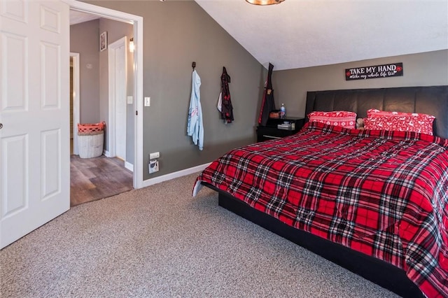 bedroom featuring carpet flooring, baseboards, and lofted ceiling