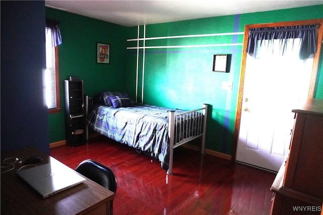 bedroom featuring baseboards and wood finished floors
