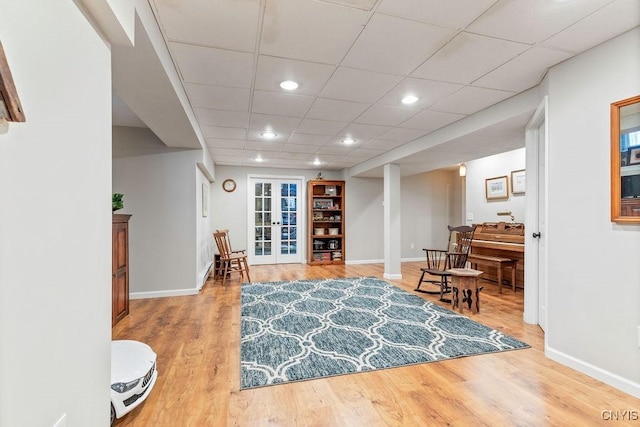 interior space with french doors, baseboards, and wood finished floors
