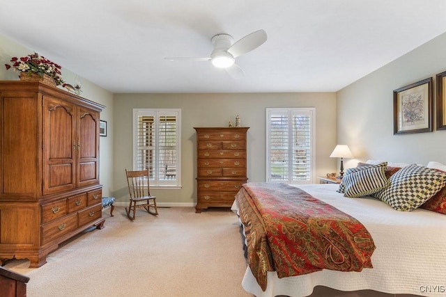 bedroom with baseboards, ceiling fan, and light carpet