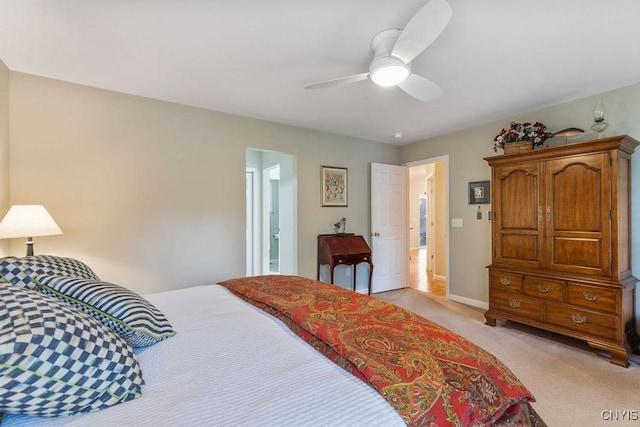 bedroom featuring baseboards, ceiling fan, and light carpet