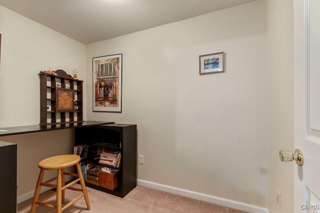 office featuring baseboards and light colored carpet