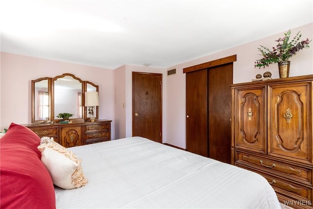 bedroom featuring visible vents and multiple closets