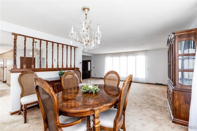 dining area featuring light colored carpet, baseboards, a chandelier, and visible vents