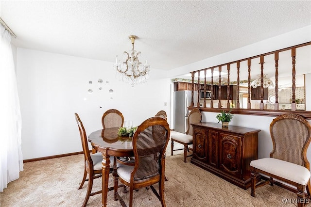 dining room with a textured ceiling, a notable chandelier, and light carpet