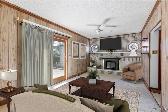 living room featuring ornamental molding, light carpet, ceiling fan, wooden walls, and a textured ceiling