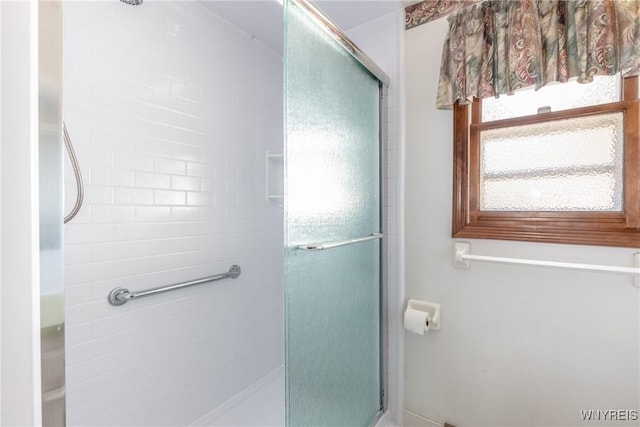 bathroom with tiled shower