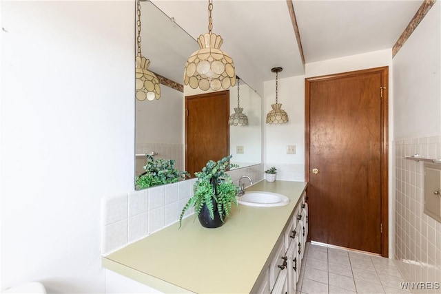 bathroom with tile patterned floors, vanity, and tile walls
