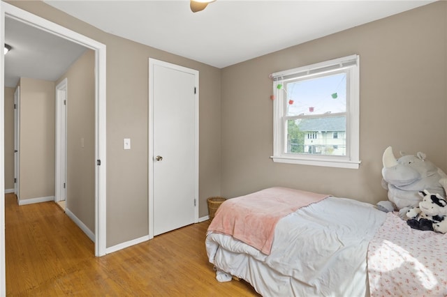 bedroom with baseboards and light wood-style flooring
