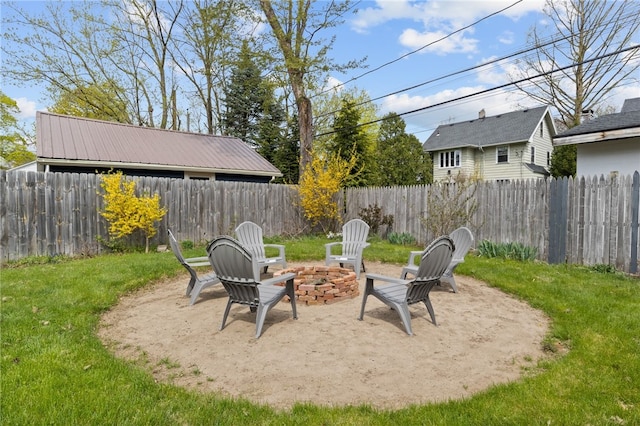 view of yard featuring a fenced backyard, a patio, and a fire pit